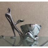 CARROL BOYES, AN ALUMINIUM TABLE CENTREPIECE Male figure with freestanding bowl resting between