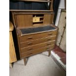 A VINTAGE ERCOL WALL MOUNTED SET OF SHELVES, along with a vintage tambour front writing chest