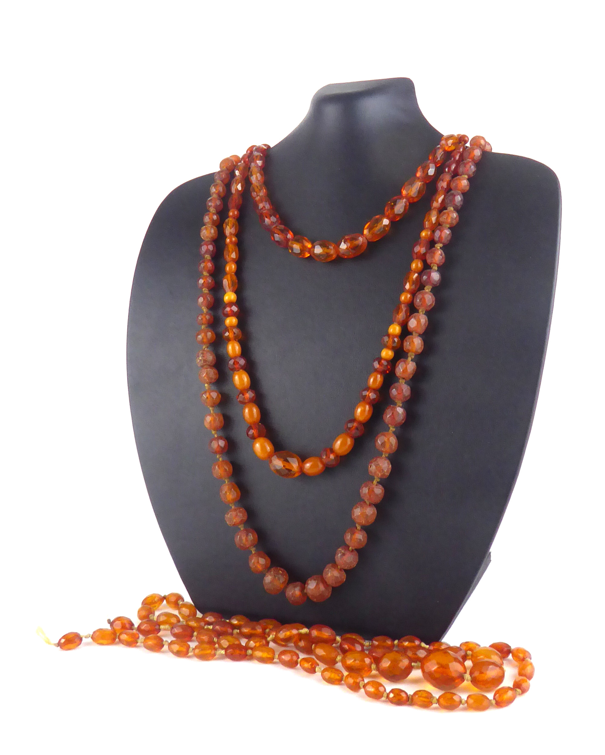 A COLLECTION OF FOUR EARLY 20TH CENTURY FACETED AMBER BEAD NECKLACES Each having a single row of