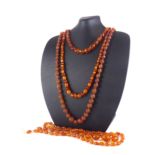A COLLECTION OF FOUR EARLY 20TH CENTURY FACETED AMBER BEAD NECKLACES Each having a single row of