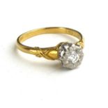 AN 18CT GOLD AND DIAMOND SOLITAIRE RING Having a round cut diamond in an illusion set mount (size