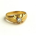 A VINTAGE 18CT GOLD AND DIAMOND GENT?S SIGNET RING Having a single round cut diamond on a raised