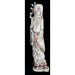 A JAPANESE MEJI PERIOD CARVED IVORY STATUE OF AN ELDER Holding a staff, bearing red seal mark. (24.