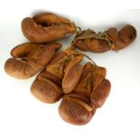 THREE PAIRS OF VINTAGE LEATHER BOXING GLOVES Two large brown leather gloves with tan leather inserts