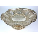 A VICTORIAN SILVER CAKE BASKET Having a swing handle and embossed and pierced decoration. (approx