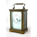 AN EARLY 20TH CENTURY FRENCH BRASS CARRIAGE CLOCK Having a carry handle with found bevelled glass