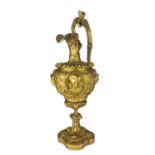 A 19TH CENTURY GILDED BRONZE EWER The scrolling handle figured with maidens heads above a