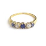 AN EARLY 18CT GOLD, DIAMOND AND SAPPHIRE FIVE STONE RING Three round cut sapphires interspersed with