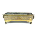 A CHINESE BRONZE RECTANGUAR PLANTER With raised decoration on trellis, bearing four character mark