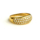 AN 18CT GOLD RING, SET WITH THREE ROWS OF DIAMONDS (SIZE Q/R).