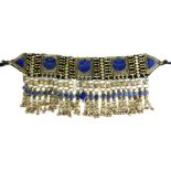 AN EARLY/MID 20TH CENTURY AFGHANI KUCHI TRIBE, WHITE METAL AND LAPIS LAZULI HEAD DRESS. (31cm)