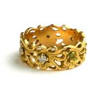 AN 18CT GOLD AND DIAMOND RING The pierced decoration of organic form.