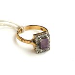 AN EDWARDIAN STYLE 9CT GOLD, AMETHYST AND DIAMOND DRESS RING The emerald cut amethyst claw set to