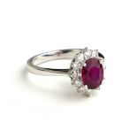 AN 18CT WHITE GOLD, OVAL CUT RUBY AND DIAMOND RING (SIZE N/O).