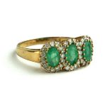 AN EDWARDIAN 9CT GOLD, DIAMOND AND EMERALD RING Three emeralds surrounded by diamonds (size N/O).