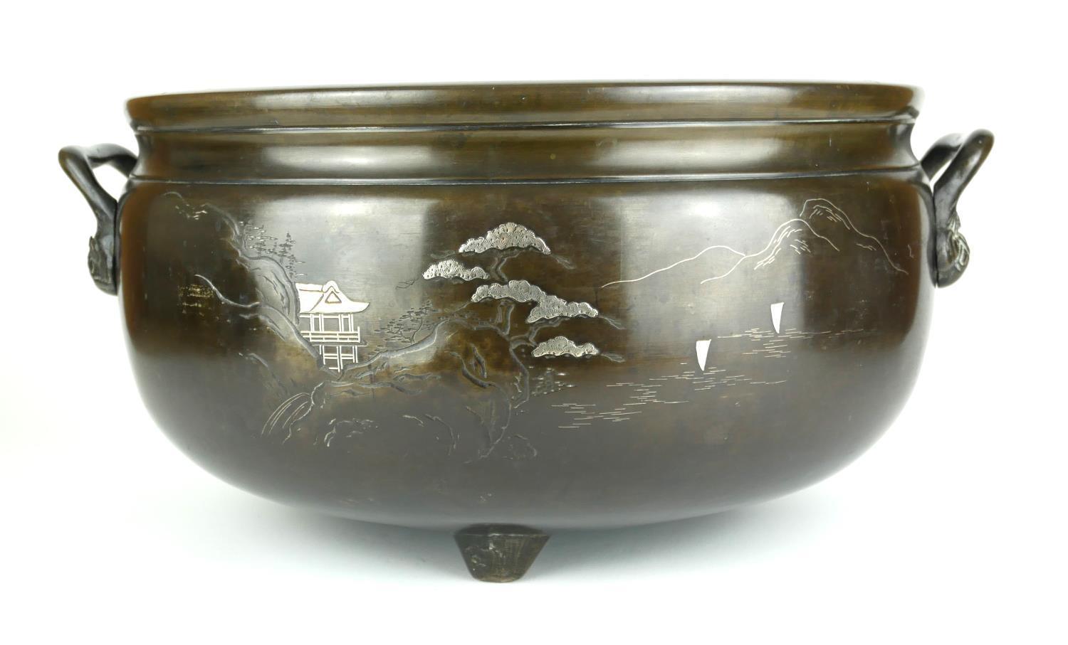 A LARGE CHINESE TWO HANDLED WHITE METAL INLAID BRONZE CENSOR Decorated with landscape scenes. (w