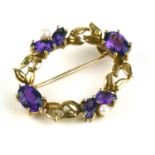 AN EARLY 20TH CENTURY 9CT GOLD, AMETHYST AND SEED PEARL BROOCH Having two pairs of pear cut
