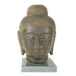 A LARGE FINELY CARVED CHINESE (POSSIBLY MING DYNASTY) GREY STONE HEAD OF A BUDDHA On a marble