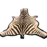 A ZEBRA SKIN RUG. (230cm x 104cm)