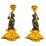 A FINE AND IMPRESSIVE PAIR OF 19TH CENTURY GILT AND PATINATED BRONZE CANDELABRA With seated putti