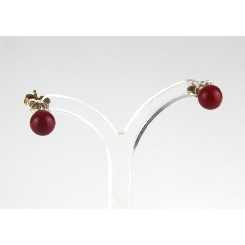 A VINTAGE PAIR OF 9CT GOLD AND CHINESE RED JASPER STUD EARRINGS Each set with a single Spherical