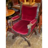 A LATE 19TH CENTURY CONTINENTAL OAK THRONE CHAIR Carved with lion masks, with red velvet upholstery.