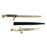 TWO EARLY 20TH CENTURY BAYONET FORM LETTER OPENERS One having a bird form handle and black scabbard,