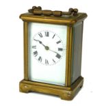 AN EARLY 20TH CENTURY GILT BRASS CARRIAGE CLOCK Having a brass carry handle, rectangular white