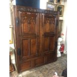 AN ANTIQUE OAK CUPBOARD With carved arcaded frieze above two panelled doors applied with