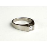 AN 18CT WHITE GOLD AND DIAMOND SOLITAIRE RING The single round cut diamond in a contemporary