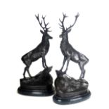 A PAIR OF BRONZE STATUES Royal stags, on black marble oval base. (74cm) Condition: good throughout