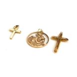 A COLLECTION OF VINTAGE 9CT GOLD RELIGIOUS PENDANTS Comprising a St. Christopher medallion and two