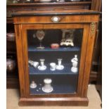 A 19TH CENTURY ROSEWOOD DISPLAY CABINET With porcelain roundel above single glazed door, on a plinth