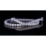 AN 18CT WHITE GOLD AND DIAMOND TENNIS BRACELET Having a single row of brilliant round cut stones. (