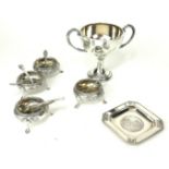 A SET OF FOUR VICTORIAN SILVER CIRCULAR SALTS With embossed decoration, on tripod feet, hallmarked