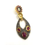 A CONTINENTAL SILVER GILT, DIAMOND RUBY AND AMETHYST PENDANT Having a rough cut diamond edged with