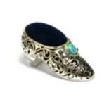 A SILVER AND OPAL NOVELTY SHOE FORM PIN CUSHION Having a doublet opal with pierced design. (approx