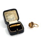A VINTAGE 9CT GOLD AND CIRINE RING The single oval cut stone in a raised mount, together with a