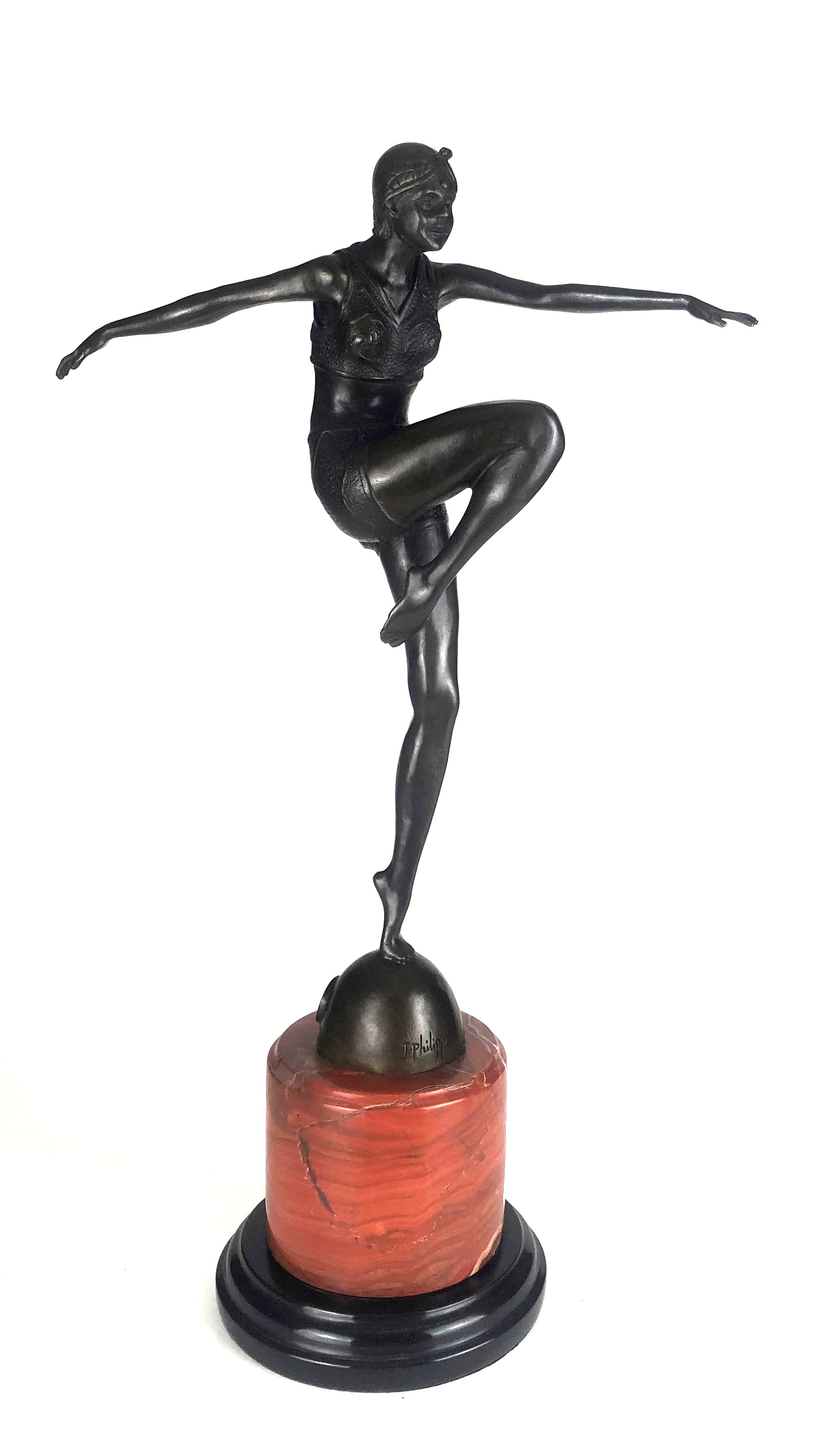 AN ART DECO STYLE BRONZE STATUE OF A SEMICLAD FEMALE DANCER On circular rouge and black marble base.