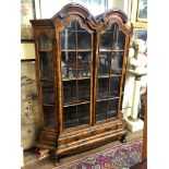 AN EARLY 19TH CENTURY DUTCH WALNUT DISPLAY CABINET With double dome above two doors flanked by