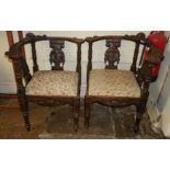 A PAIR OF LATE 19TH CENTURY ITALIAN OAK CORNER CHAIRS The top rail carved with winged cherubs,