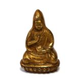 A SMALL CHINESE/TIBETAN GILT BRONZE BUDDHA Seated pose holding a bowl, on lotus form base. (approx
