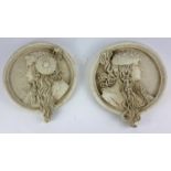 A PAIR OF CIRCULAR PLASTER RELIEF WALL PLAQUES Depicting classical maidens. (19cm x 22cm)