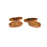 A PAIR OF EARLY 20TH CENTURY 9CT GOLD OVAL CUFFLINKS With engraved decoration. (approx 2cm)