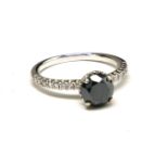 A VINTAGE 18CT WHITE GOLD AND BLACK DIAMOND RING The single round cut fancy black diamond in a