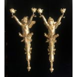 A PAIR OF GILDED BRONZE ART NOVEAU STYLE TWIN BRANCH WALL SCONCES In the form of cherubs above