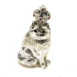 A STERLING SILVER NOVELTY 'CAT' FIGURE Seated pose wearing a glass set crown. (approx 4cm)