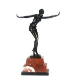 AN ART DECO DESIGN BRONZE STATUE OF A SEMICLAD EGYPTIAN DANCER On a stepped rouge and black marble