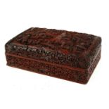 A CHINESE CINNABAR LAQUER RECTANGULAR BOX With fine carved decoration of figures in a mountainous