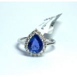 AN 18CT WHITE GOLD AND 2.4CT SAPPHIRE AND DIAMOND RING The single pear cut sapphire edged with round